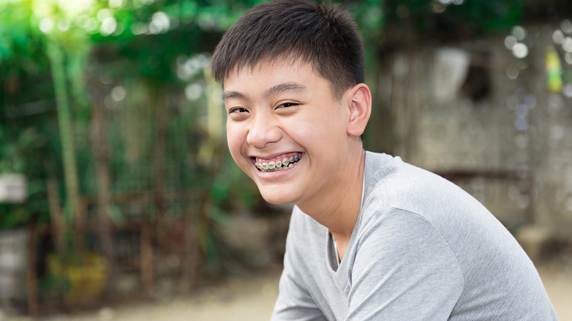 Boy Smiling With Braces During Orthodontic Treatment